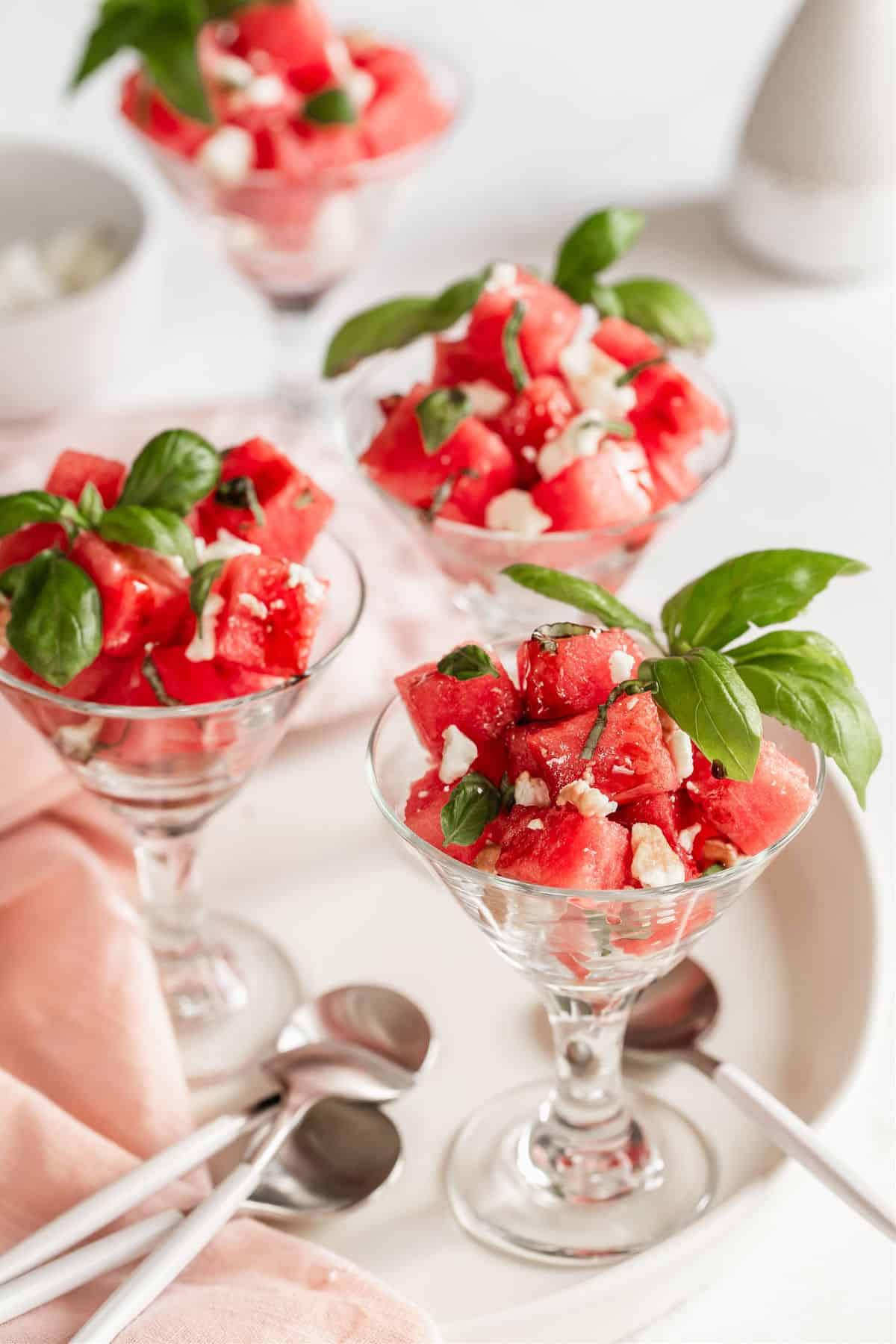 watermelon salad served in mini glass cups on white tray
