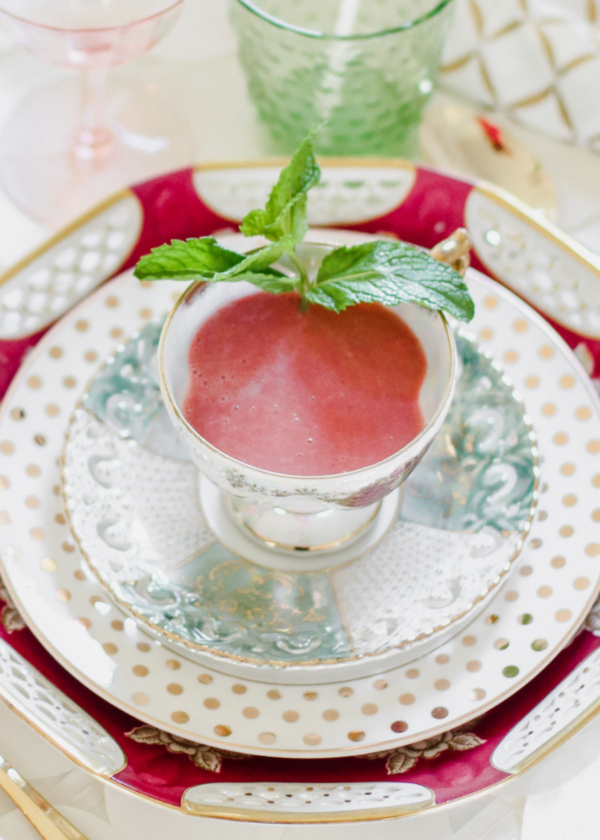 chilled pink soup in tea cup on plates.