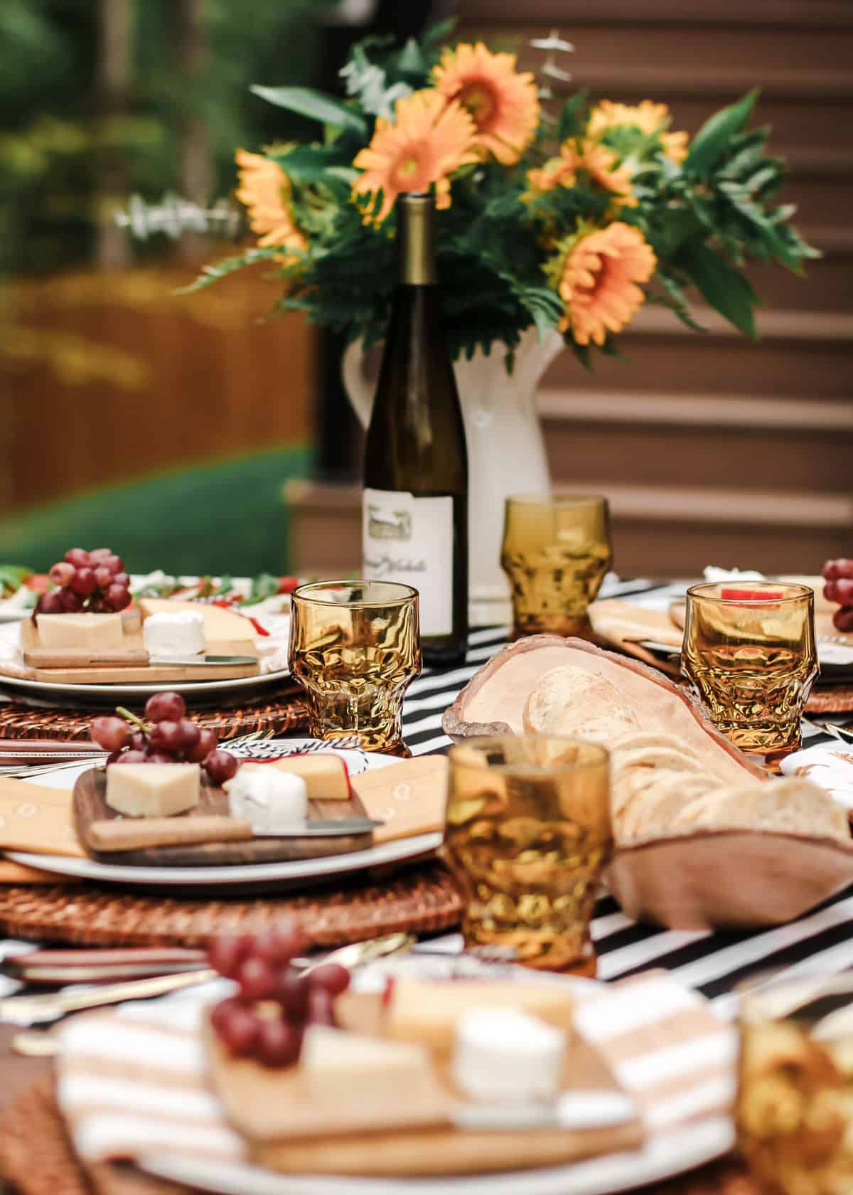outdoor table setting for fall with sunflowers centerpiece.