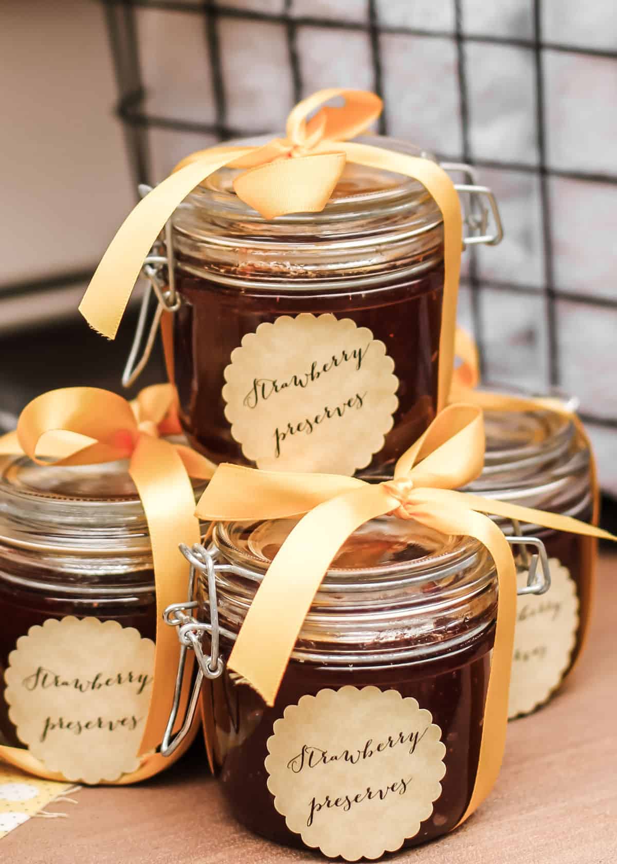 homemade jam in glass jars with ribbon and tag.