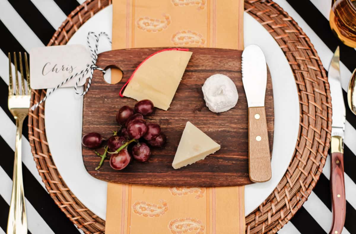 small individual cheese board on top of place setting.
