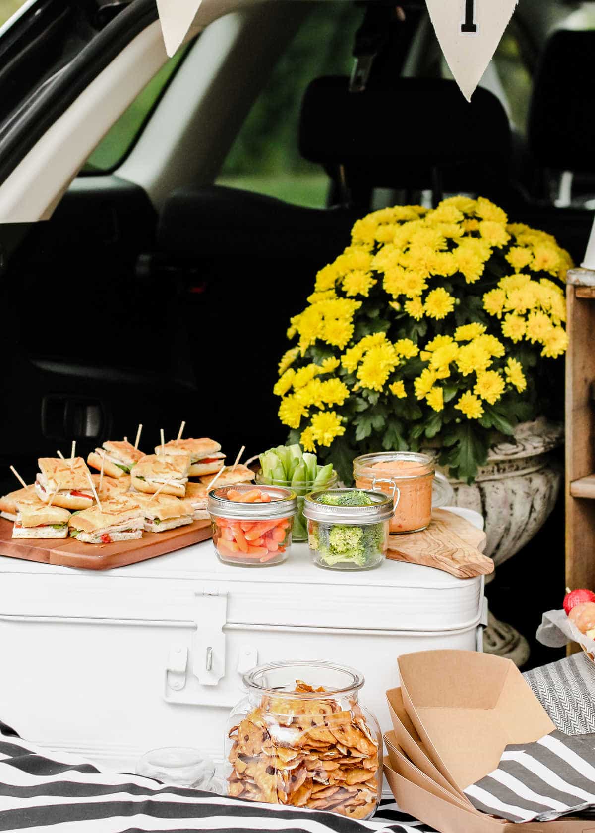 tailgate trunk with food and flowers set up.