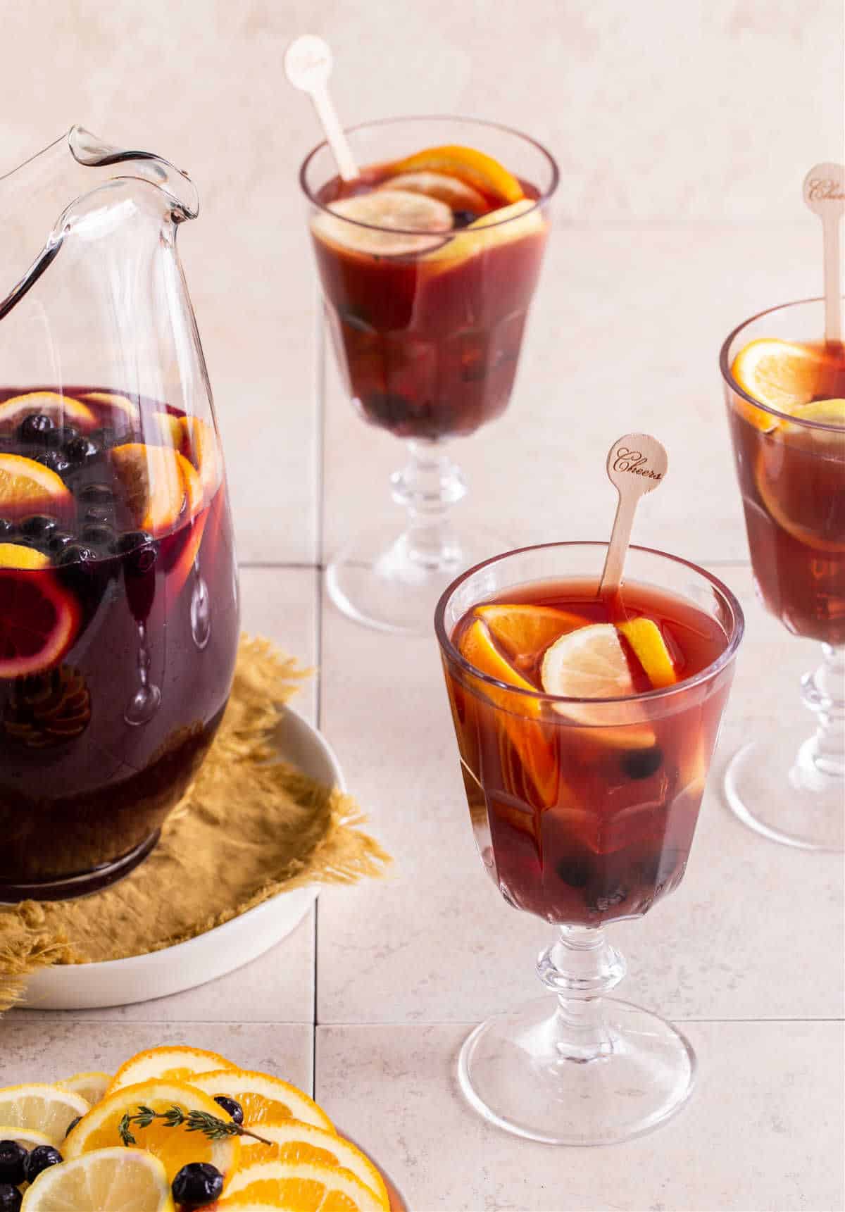 red sangria in pitcher with 3 filled glasses
