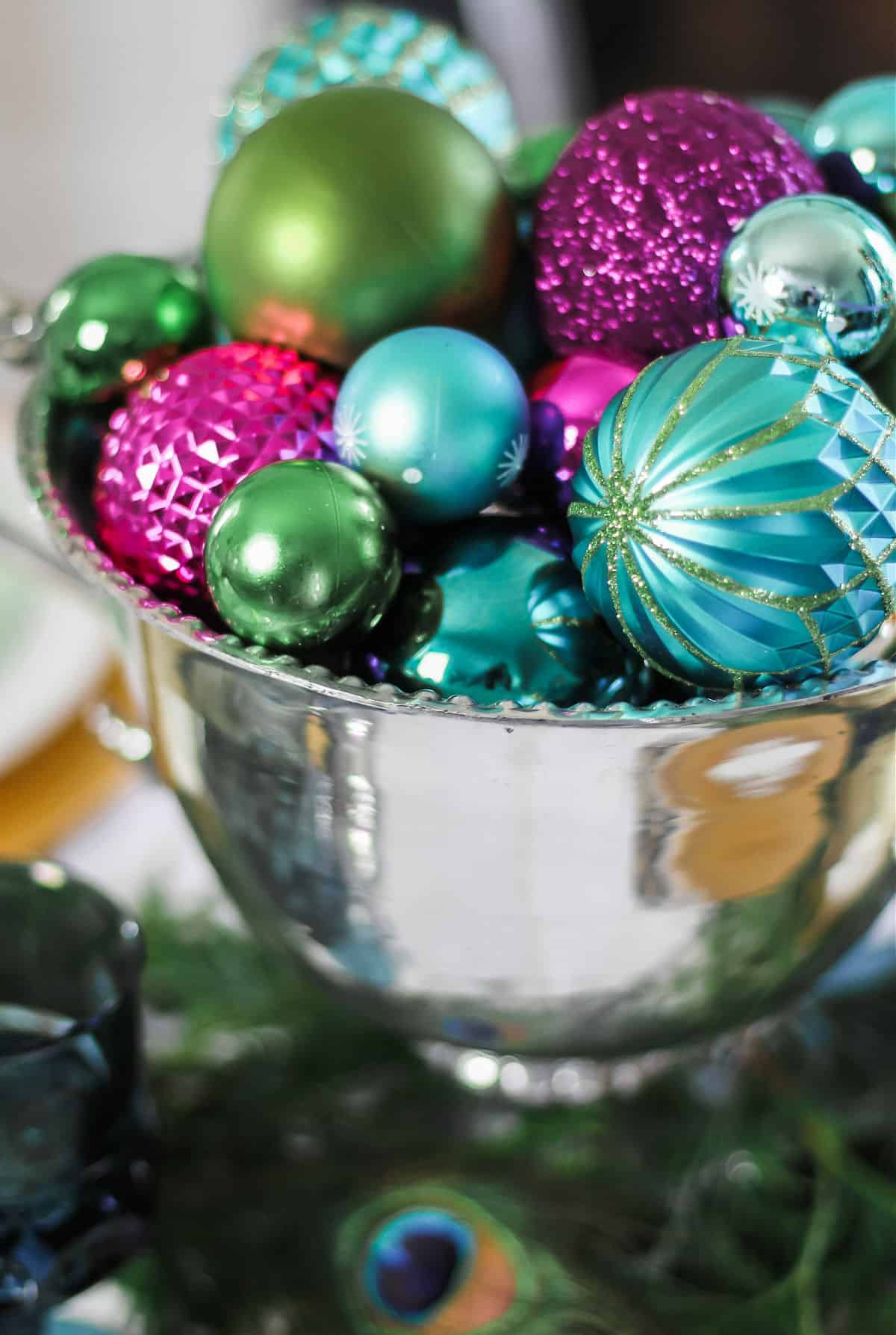 silver urn with Christmas ornaments inside