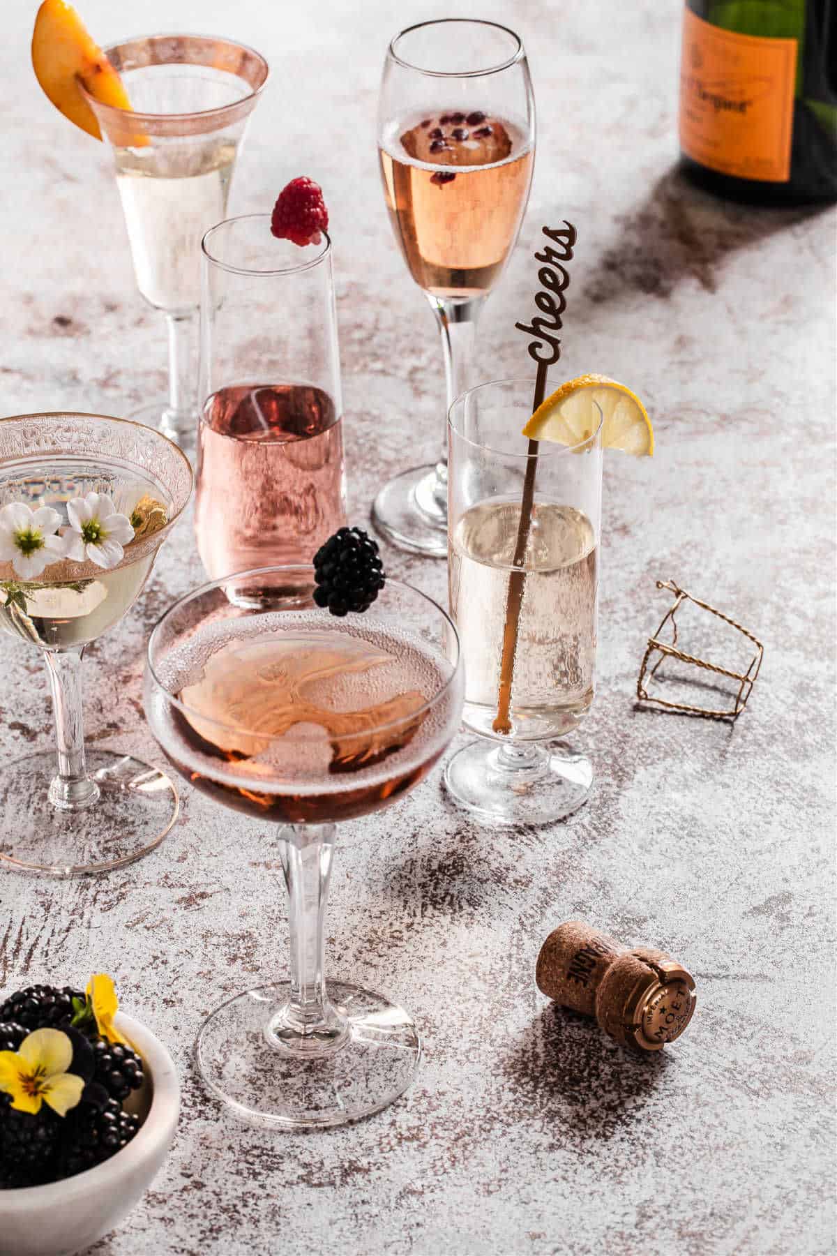 champagne cocktails in different glasses, on table