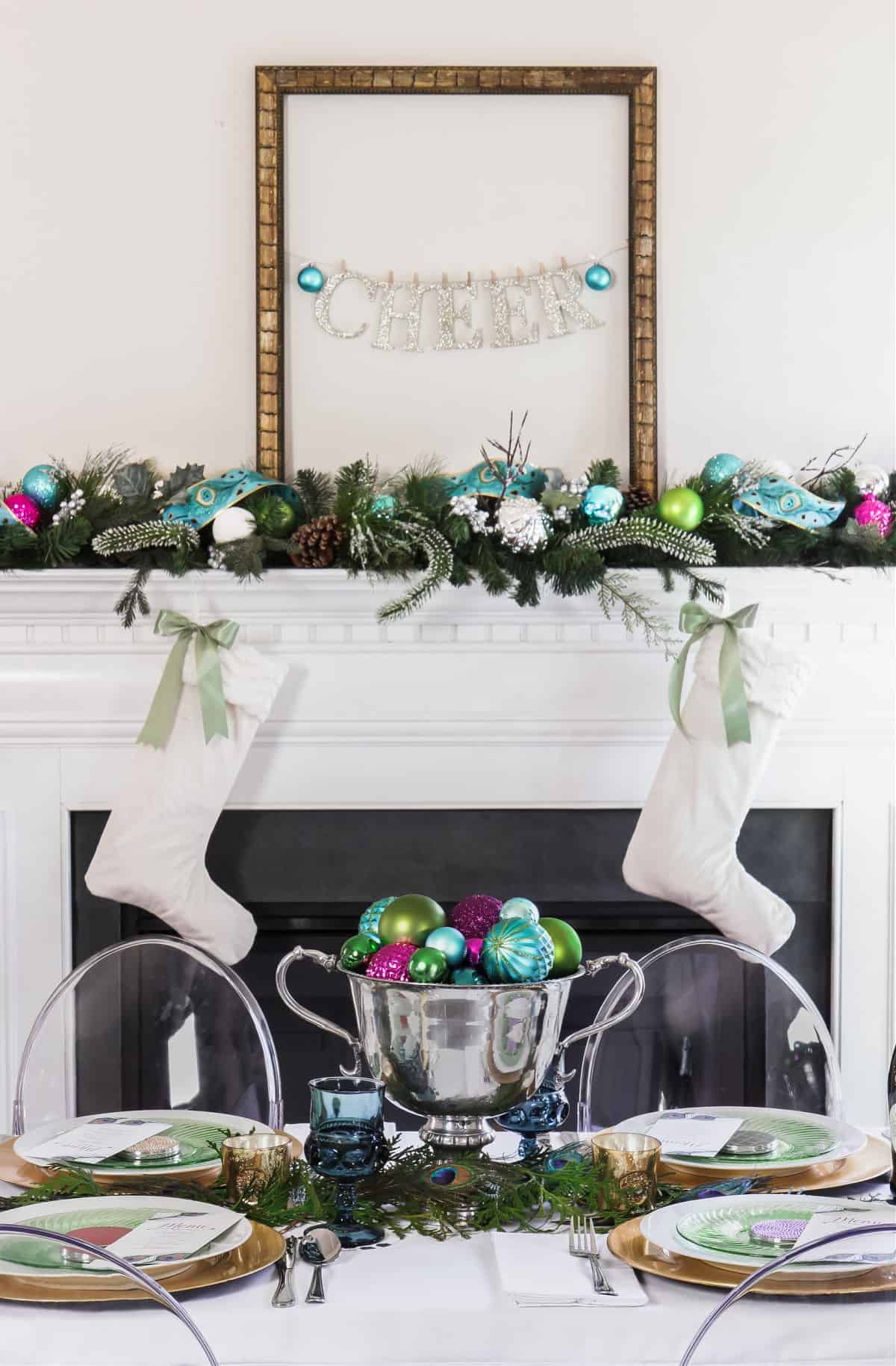 fireplace decorated for Christmas with dinner table in front