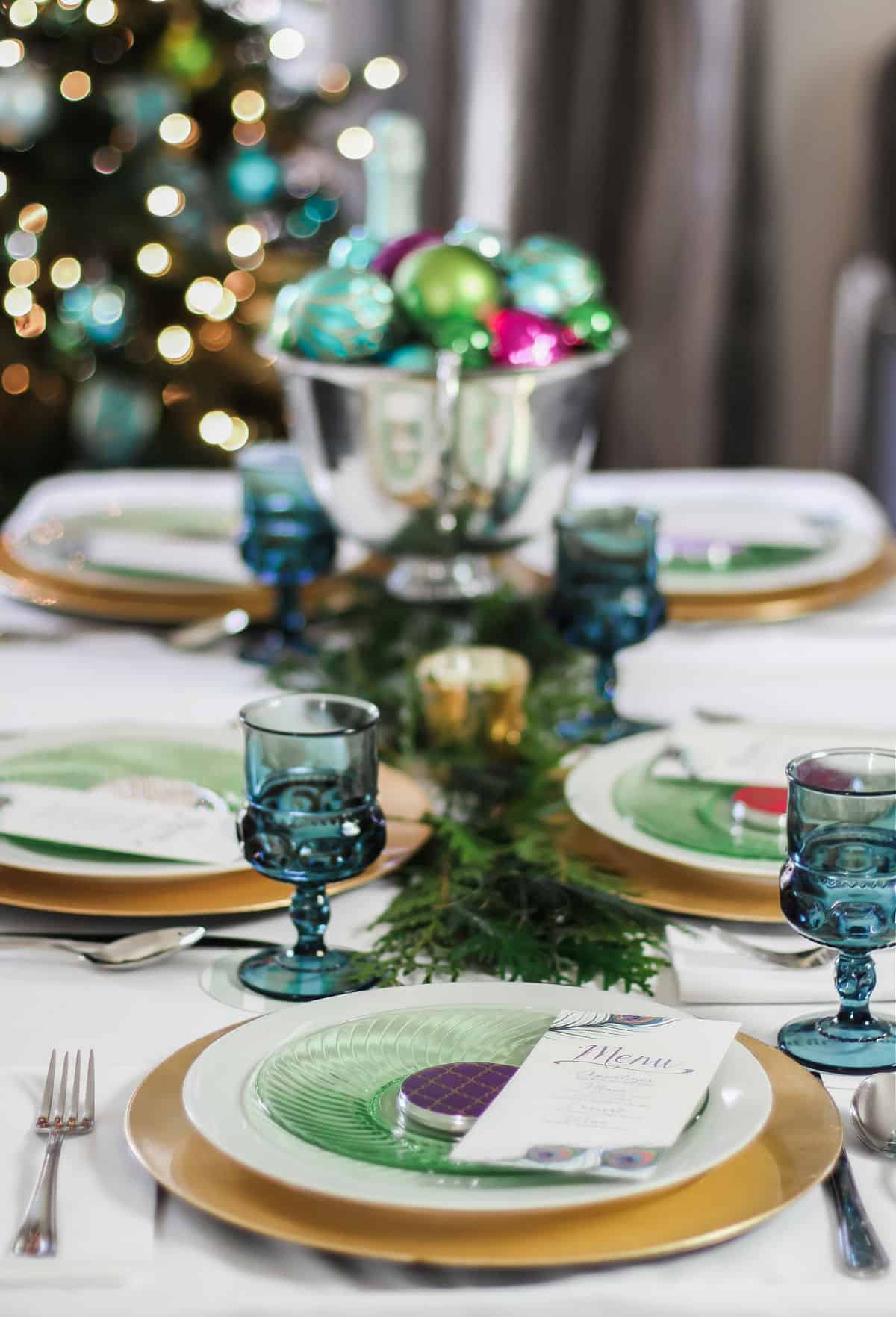 dinner table set with green and gold place settings