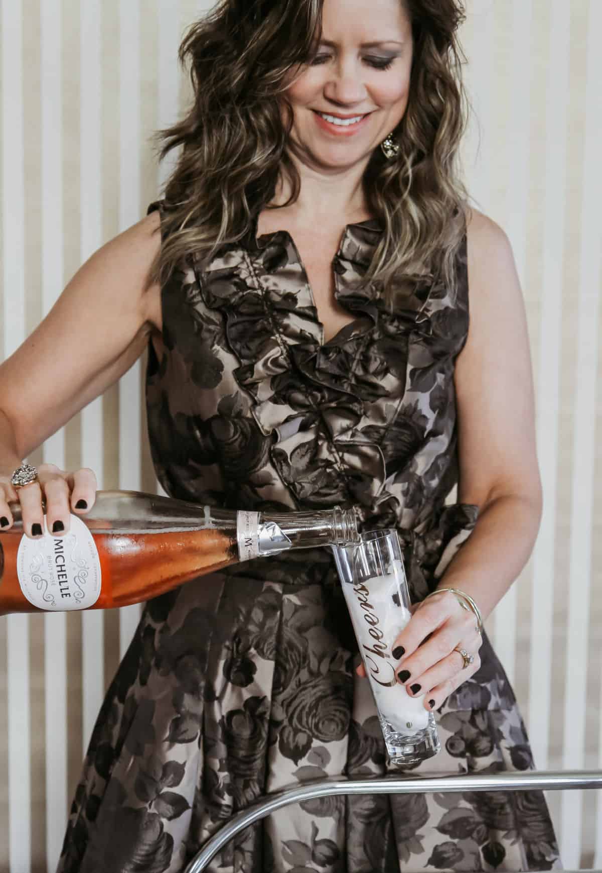 lady pouring pink champagne into glass