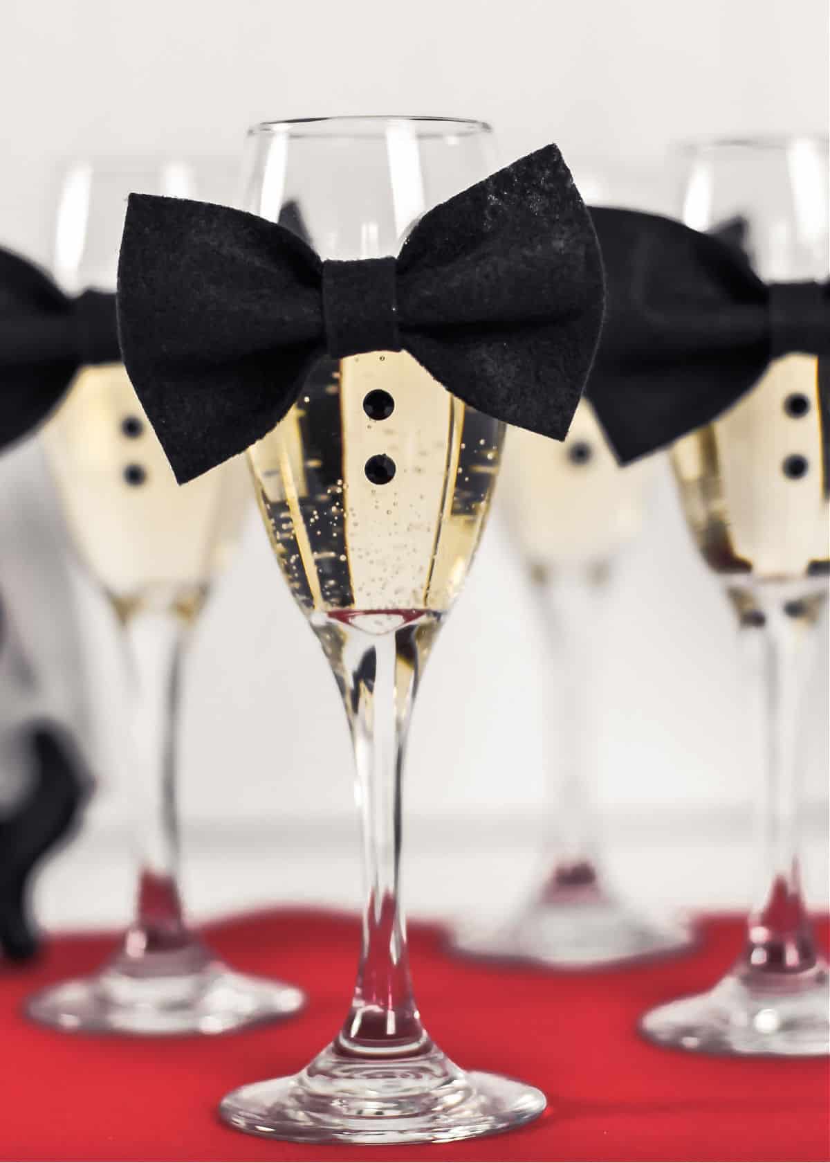 champagne flutes with mini bow ties attached