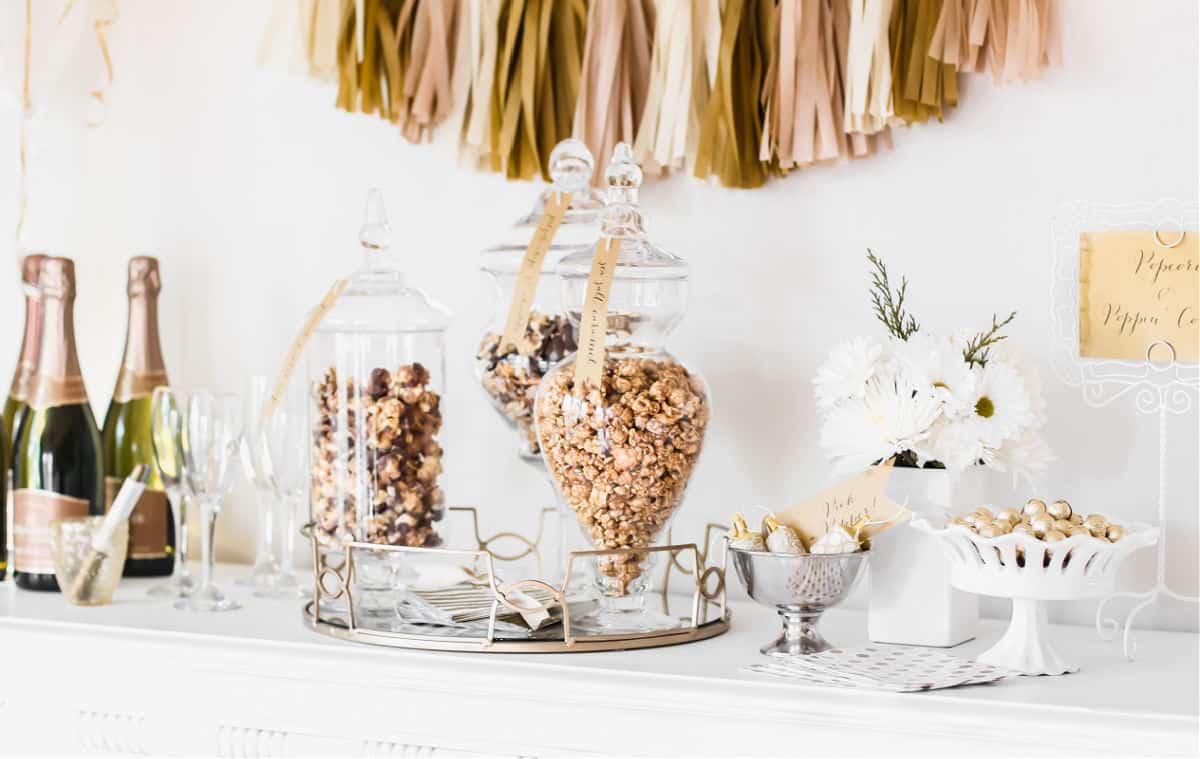 jars of popcorn and champagne bottles on white table