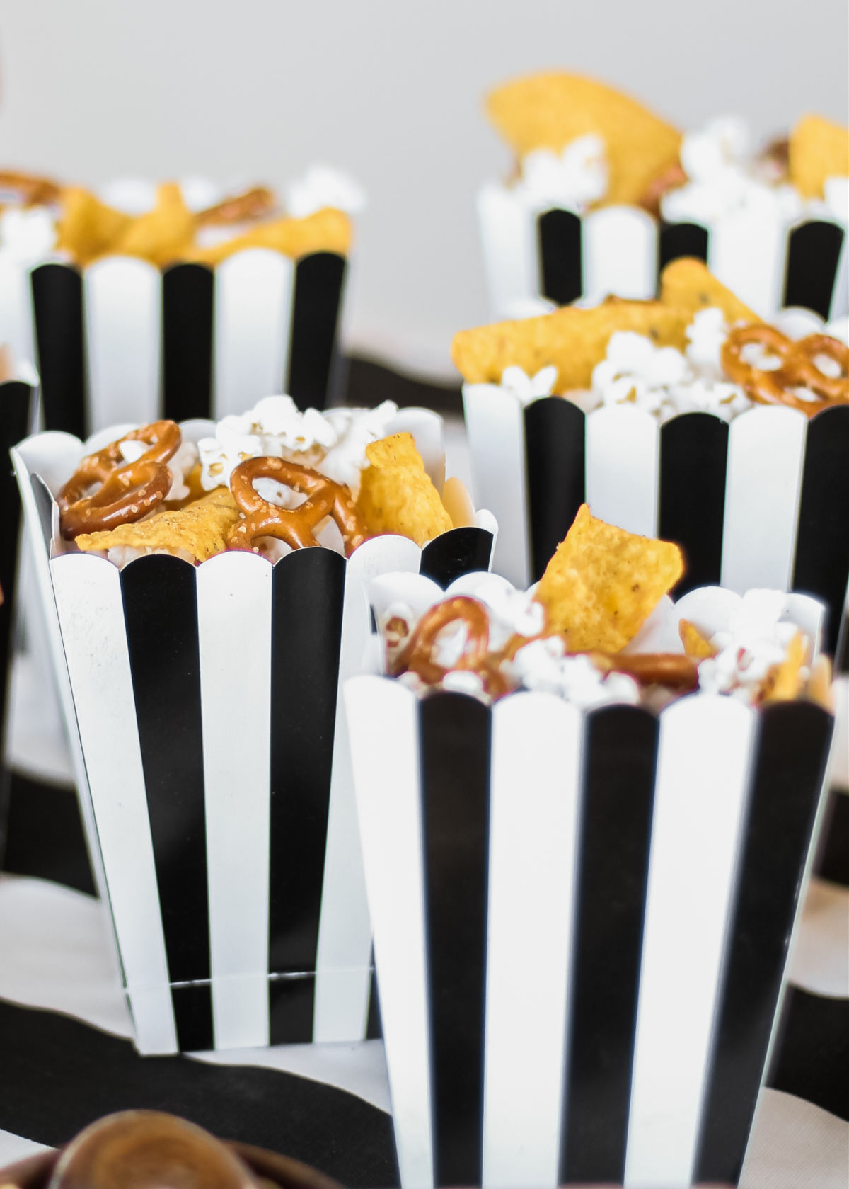 black and white stripe popcorn boxes with snacks inside.