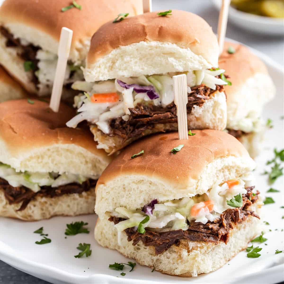slow cooker bbq beef party sandwiches recipe on white platter.
