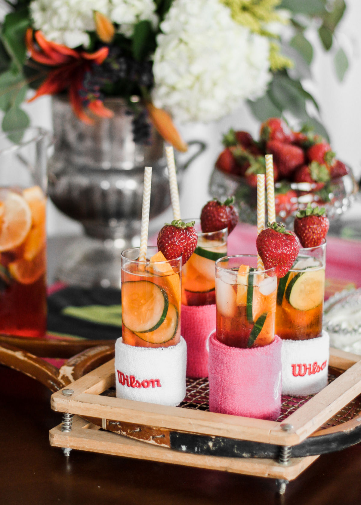 glasses of Pimms punch with wrist band holders for tennis decor.