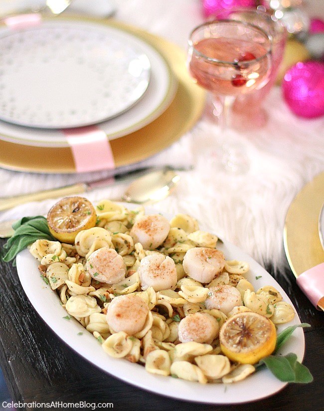 white & pink Christmas tablescape with scallops over pasta for entree