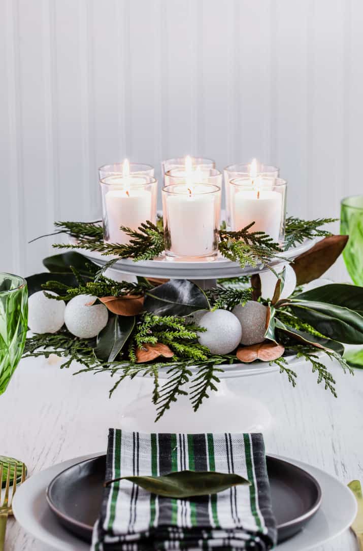 cake stand centerpiece with greenery and candles