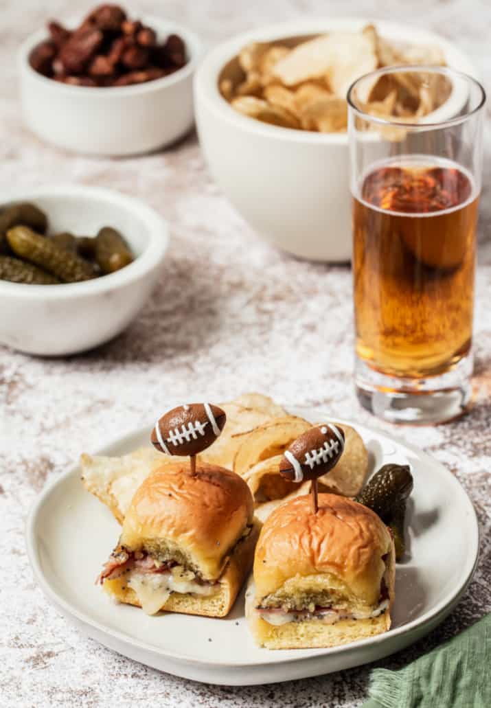 mini party sandwiches with football picks on top