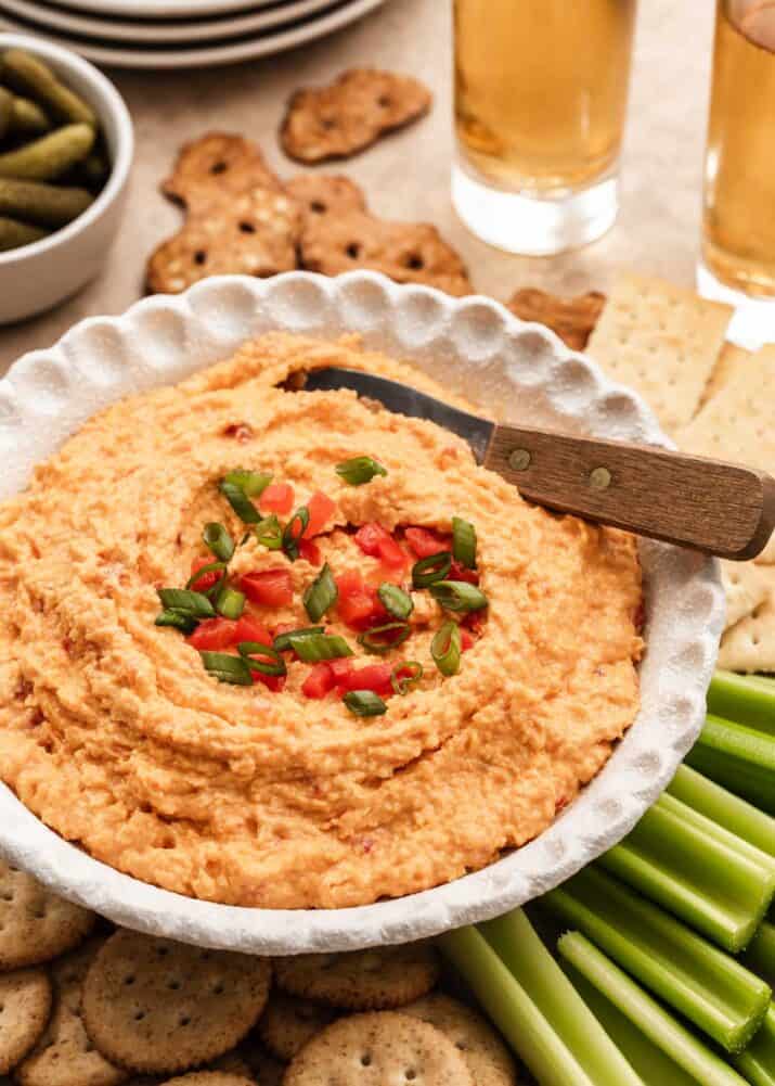 pimento cheese spread in white bowl, with knife.