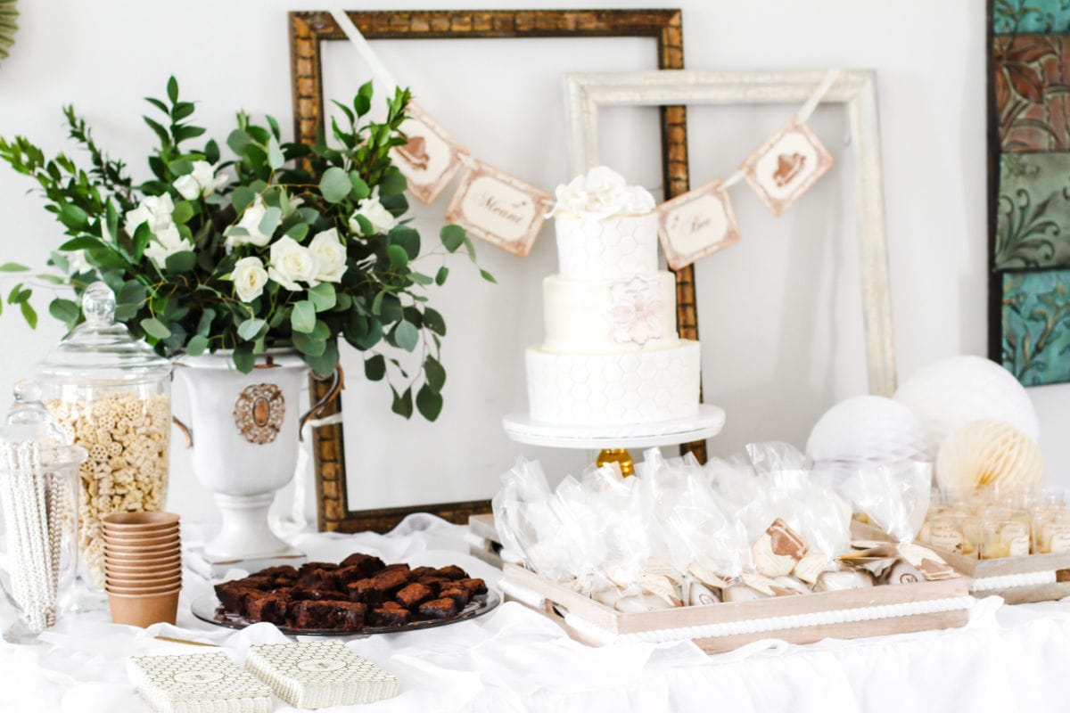 Meant to Bee themed dessert table with cake and other treats.