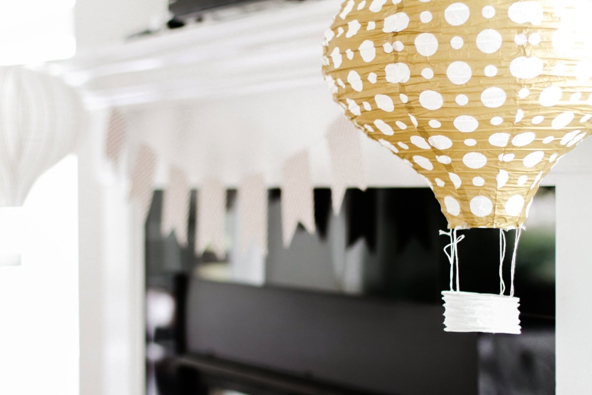 paper hot air balloon decorations hanging from fireplace mantel. 
