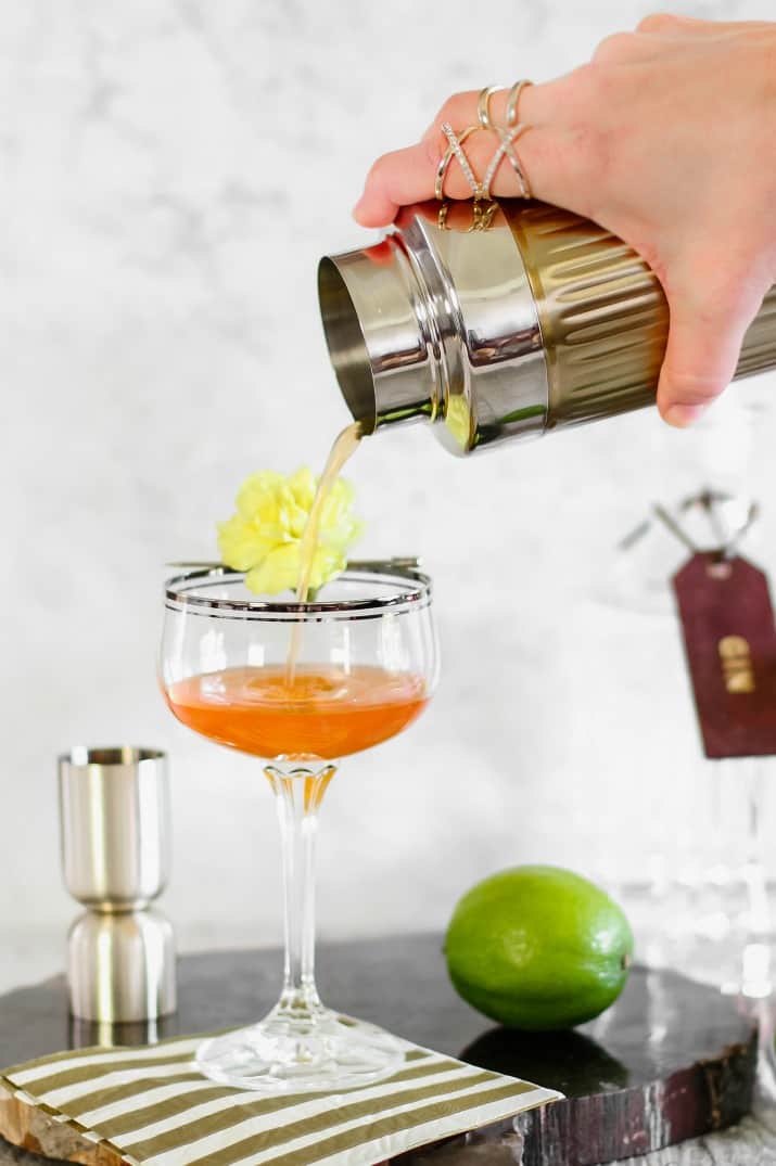 pouring cocktail into coup