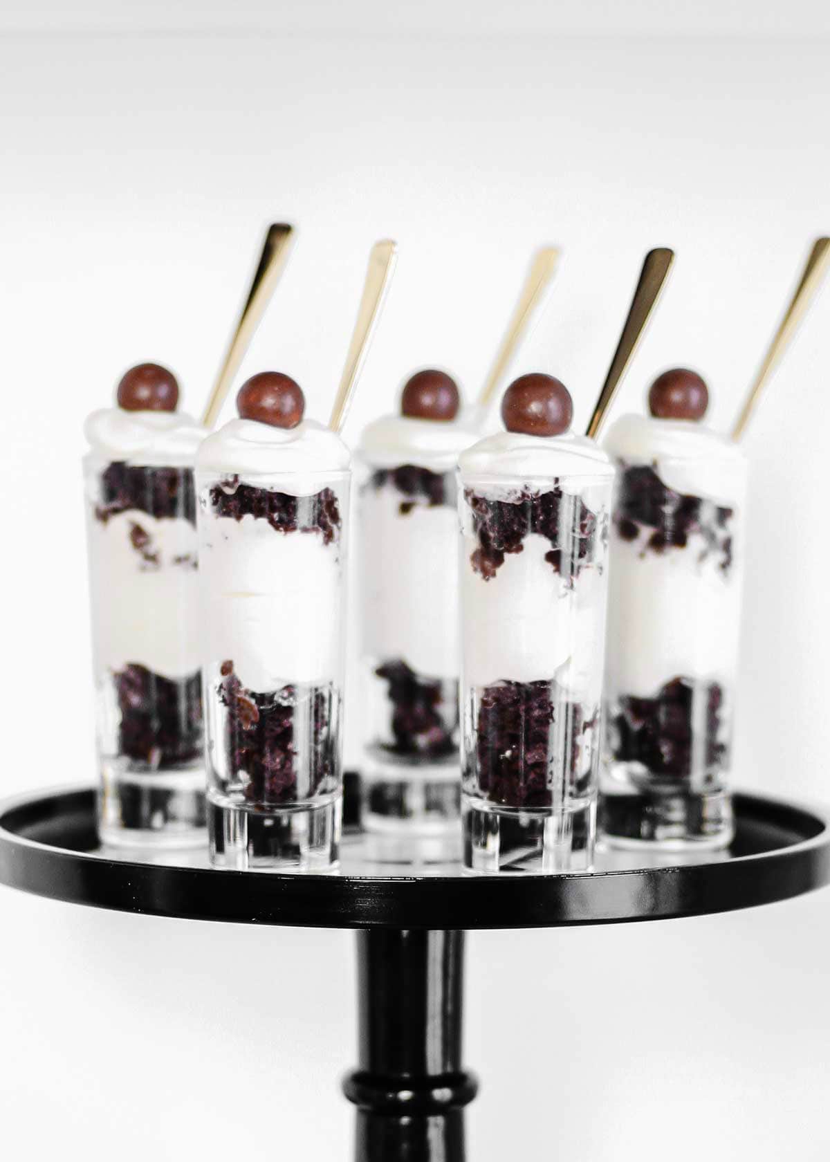 black and white dessert parfaits in tall jars.