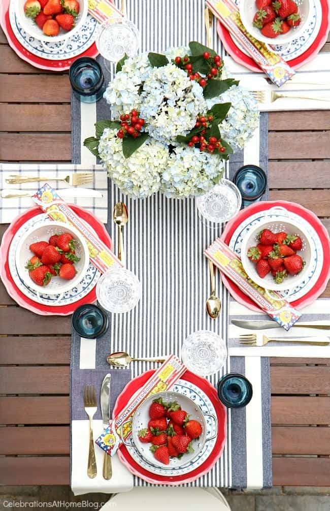 Celebrate the 4th of July with a red white & blue party tablescape! Get inspiration for a July 4th party with these photos and tips from entertaining expert, Chris Nease of Celebrations At Home. #tablescape #4thofjuly #july4th #outdoortablescape #redwhiteblue #summerdinnerparty July 4th table setting