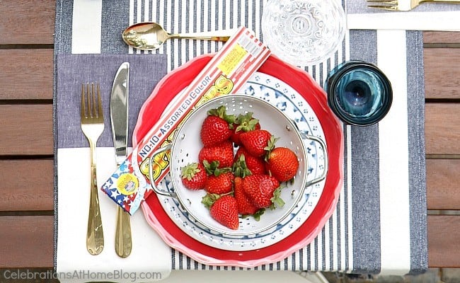 Celebrate July 4th with a red white & blue party tablescape! Get inspiration for a 4th of July party with these photos and tips from entertaining expert, Chris Nease of Celebrations At Home. #tablescape #4thofjuly #july4th #outdoortablescape #redwhiteblue #summerdinnerparty red white & blue party place setting