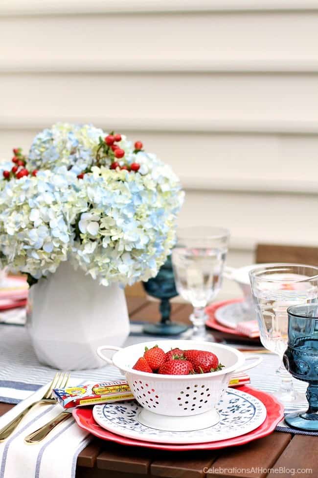 Celebrate the 4th of July with a red white & blue party tablescape! Get inspiration for a July 4th party with these photos and tips from entertaining expert, Chris Nease of Celebrations At Home. #placesetting #tablescape #4thofjuly #july4th #outdoortablescape #redwhiteblue #summerdinnerparty red white & blue party tablescape place setting
