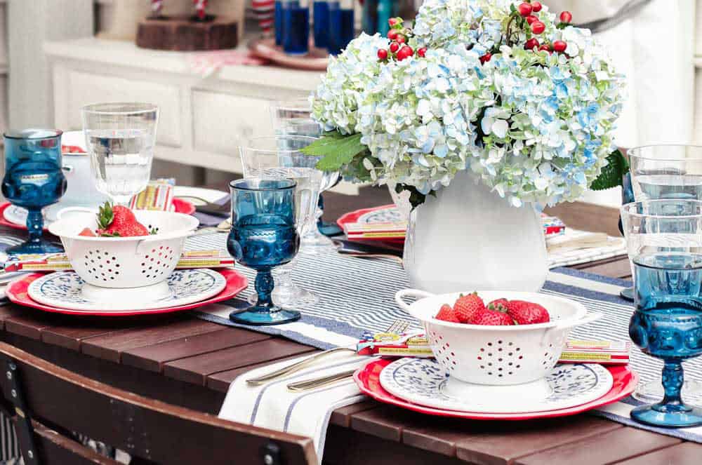 outdoor tablescape with red, white and blue decor.