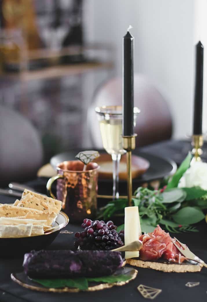 Black & gold table setting with cheese and charcuterie