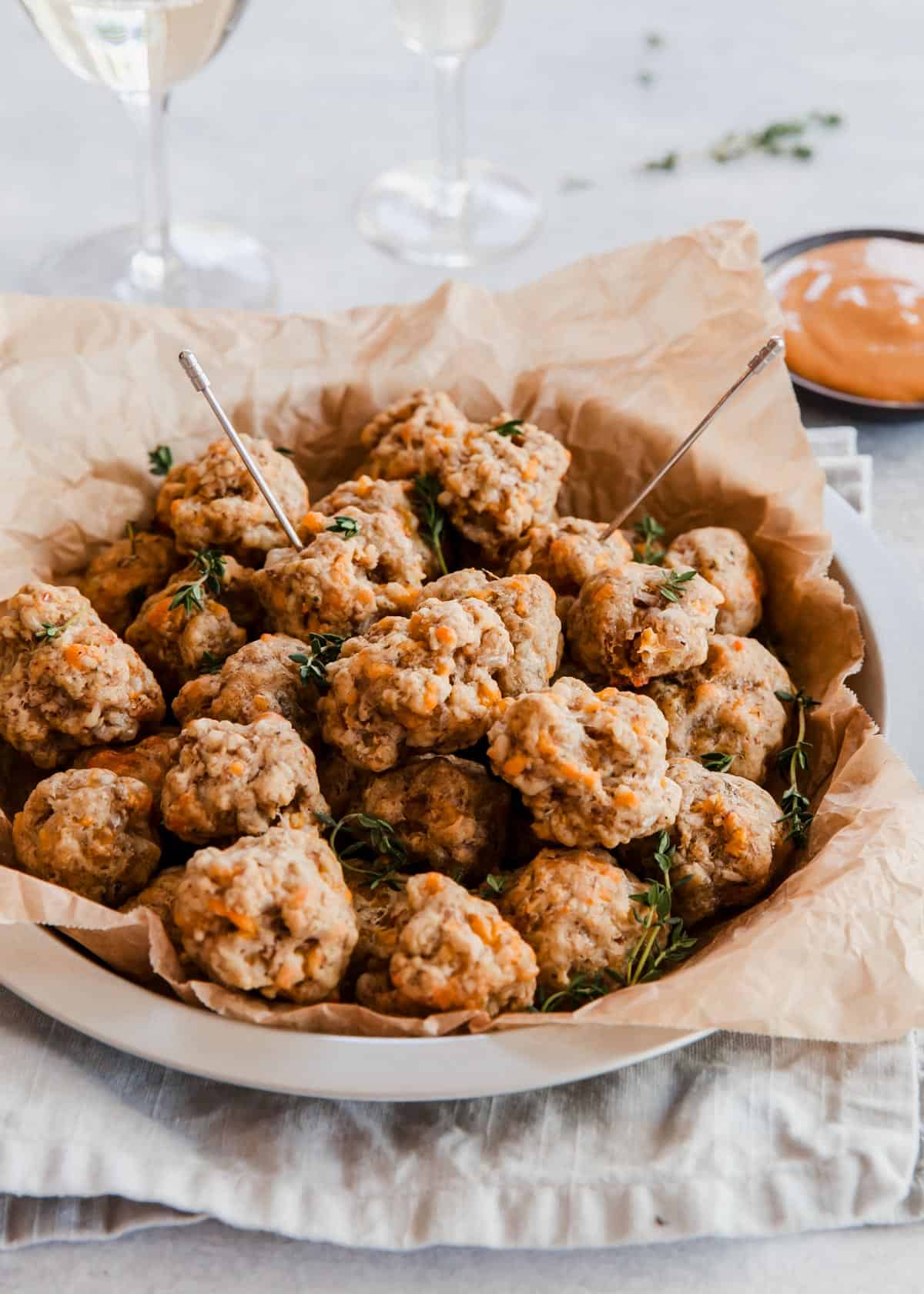 sausage balls on serving plate with picks.