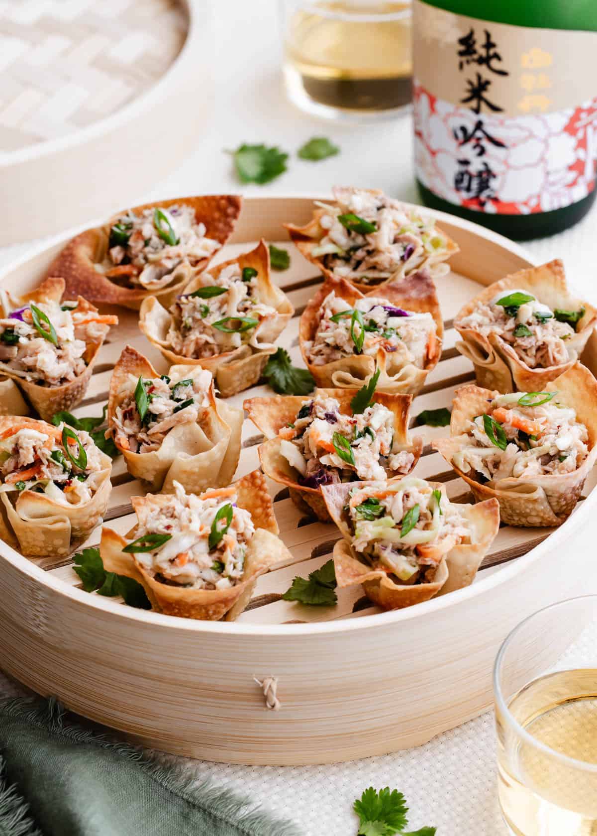 tuna salad in wonton cups in party table setting.