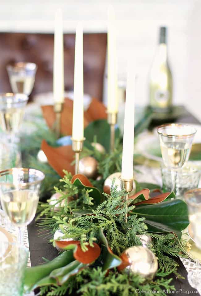 fresh greenery runner with magnolia leaves and candles