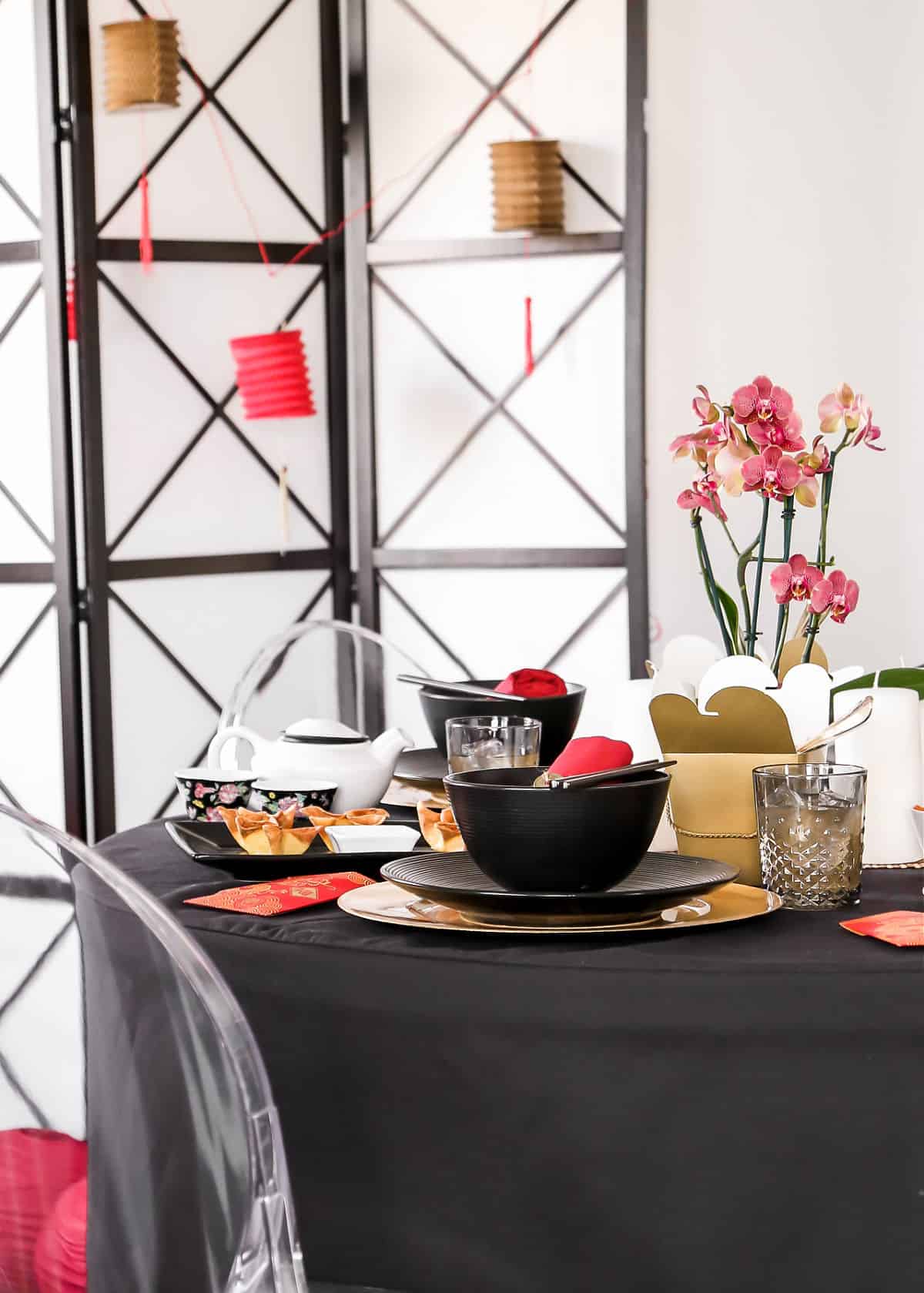 Chinese themed party decoration and tablescape in black, red, and gold