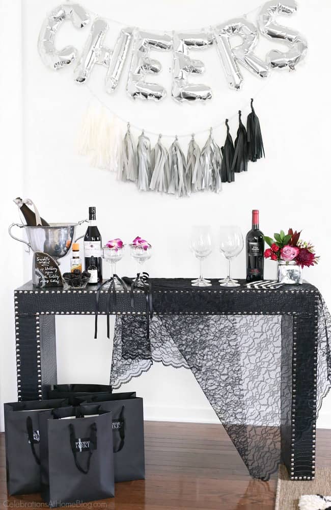 Host a ladies night cocktail party with these ideas for decorating, signature cocktail, food, and fun! Host this black & white & silver party as a precursor to a night out, or to watch the new movie, Fifty Shades Darker!
