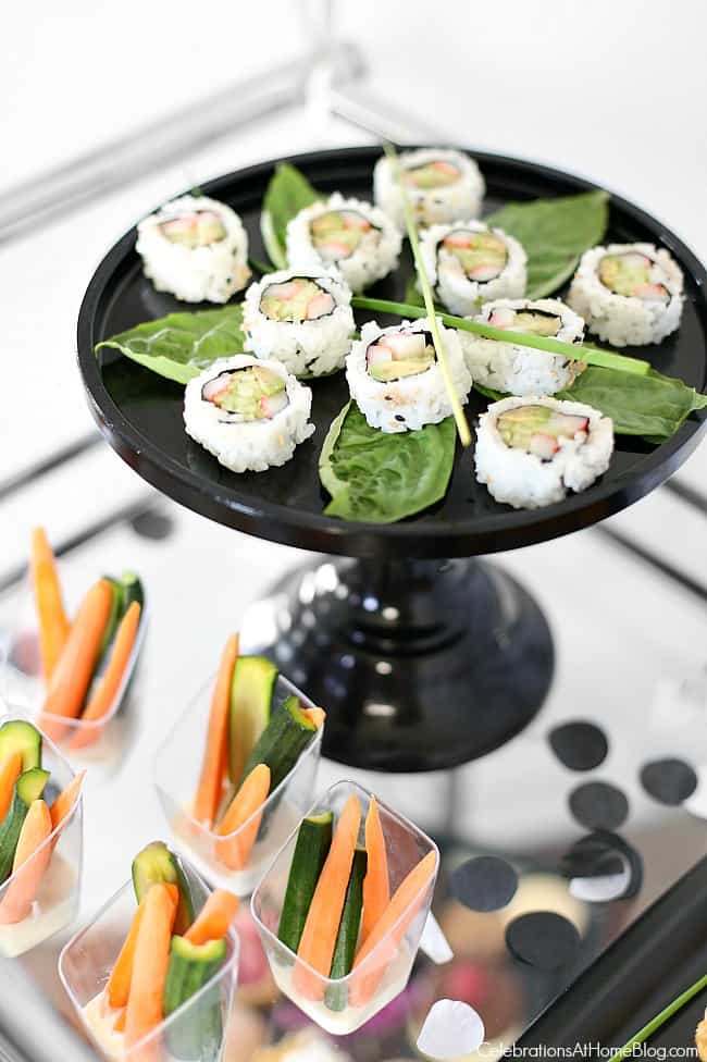 Host a ladies night cocktail party with these ideas for decorating, signature cocktail, food, and fun! Host this black & white & silver party as a precursor to a night out, or to watch the new movie, Fifty Shades Darker!