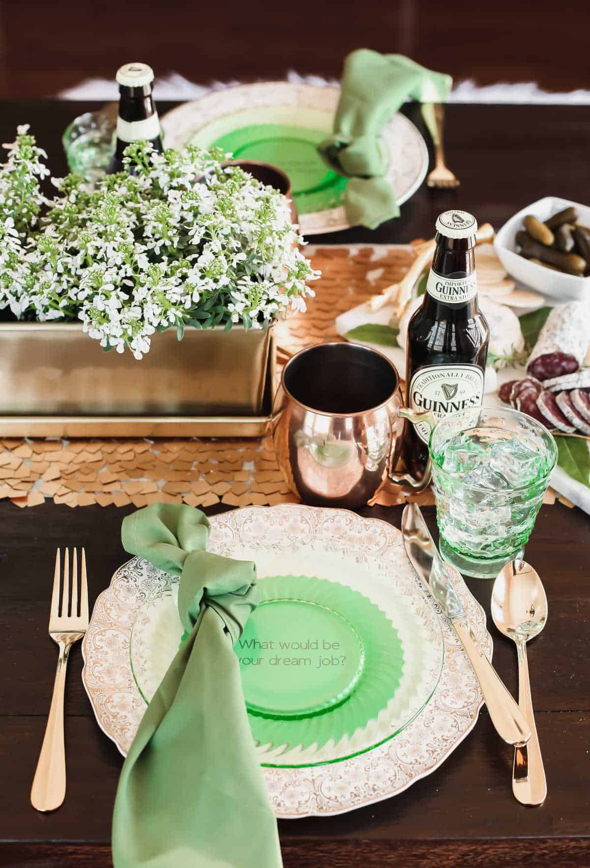 Irish theme dinner party table setting with green and gold decor.
