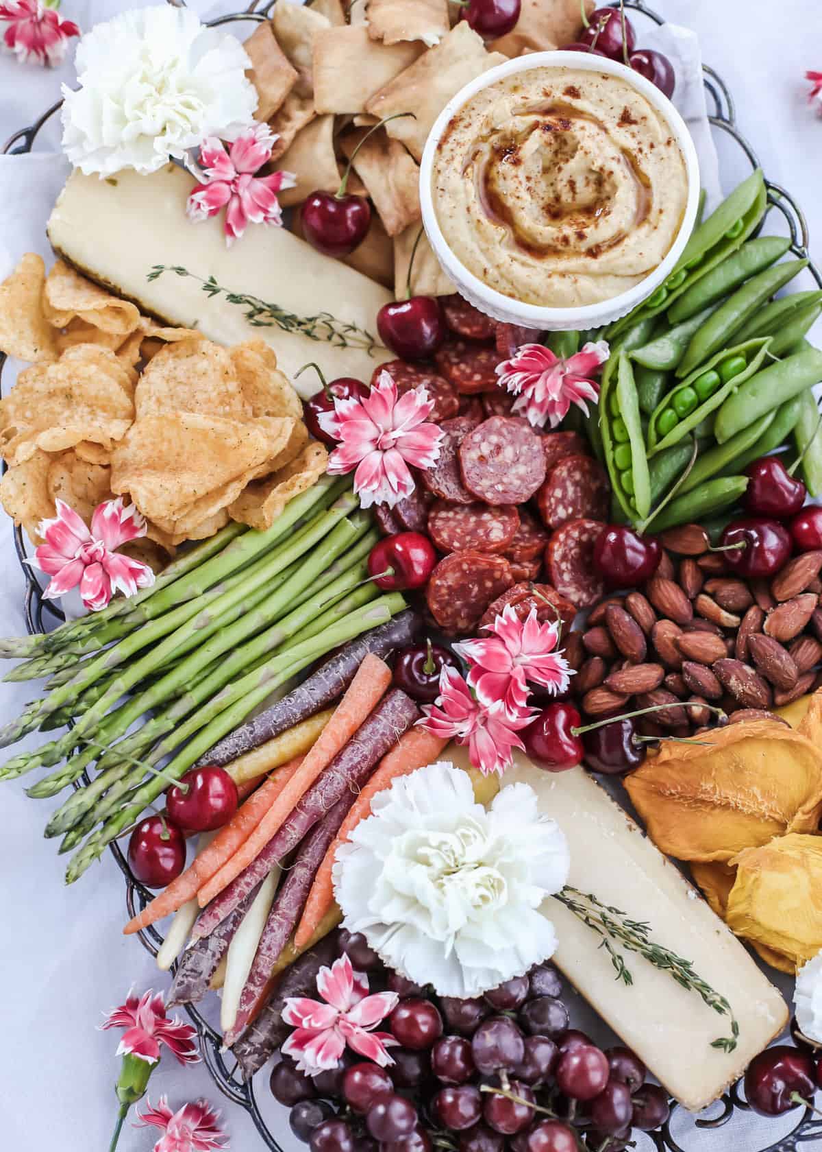 overhead view of charcuterie and cheese and vegetables on party tray.