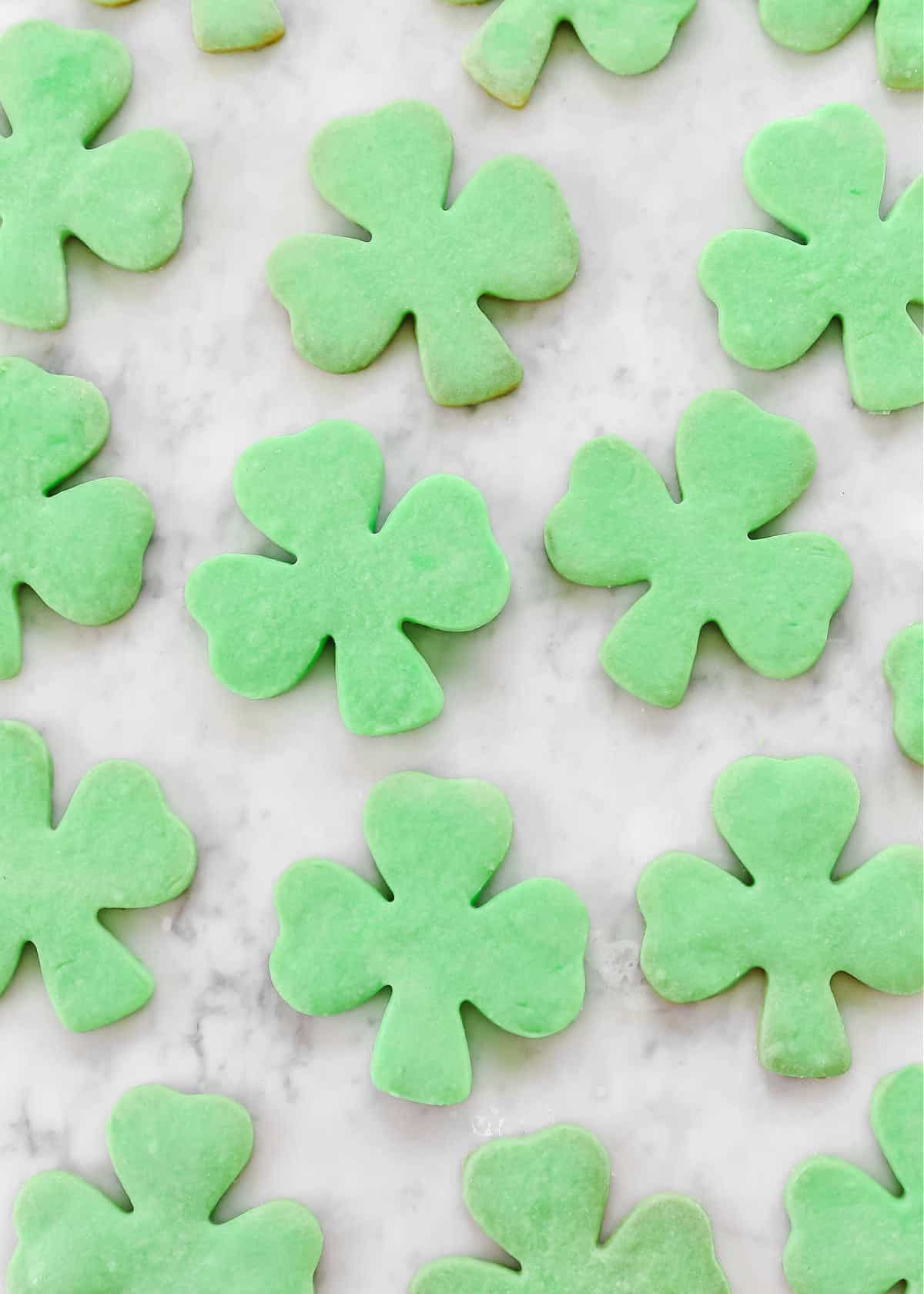 green shamrock shaped cookies on marble.