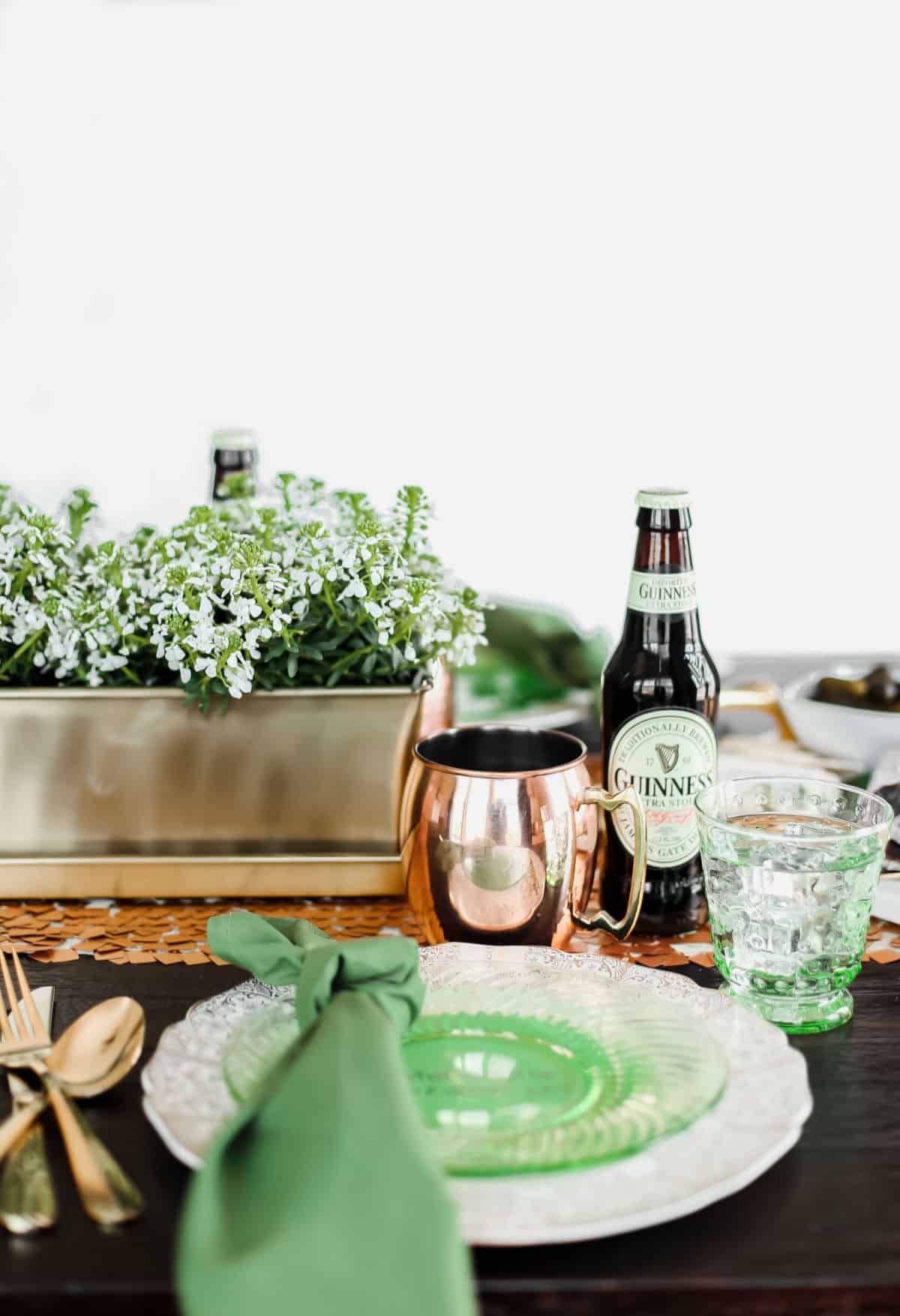 green and gold table setting with white background.