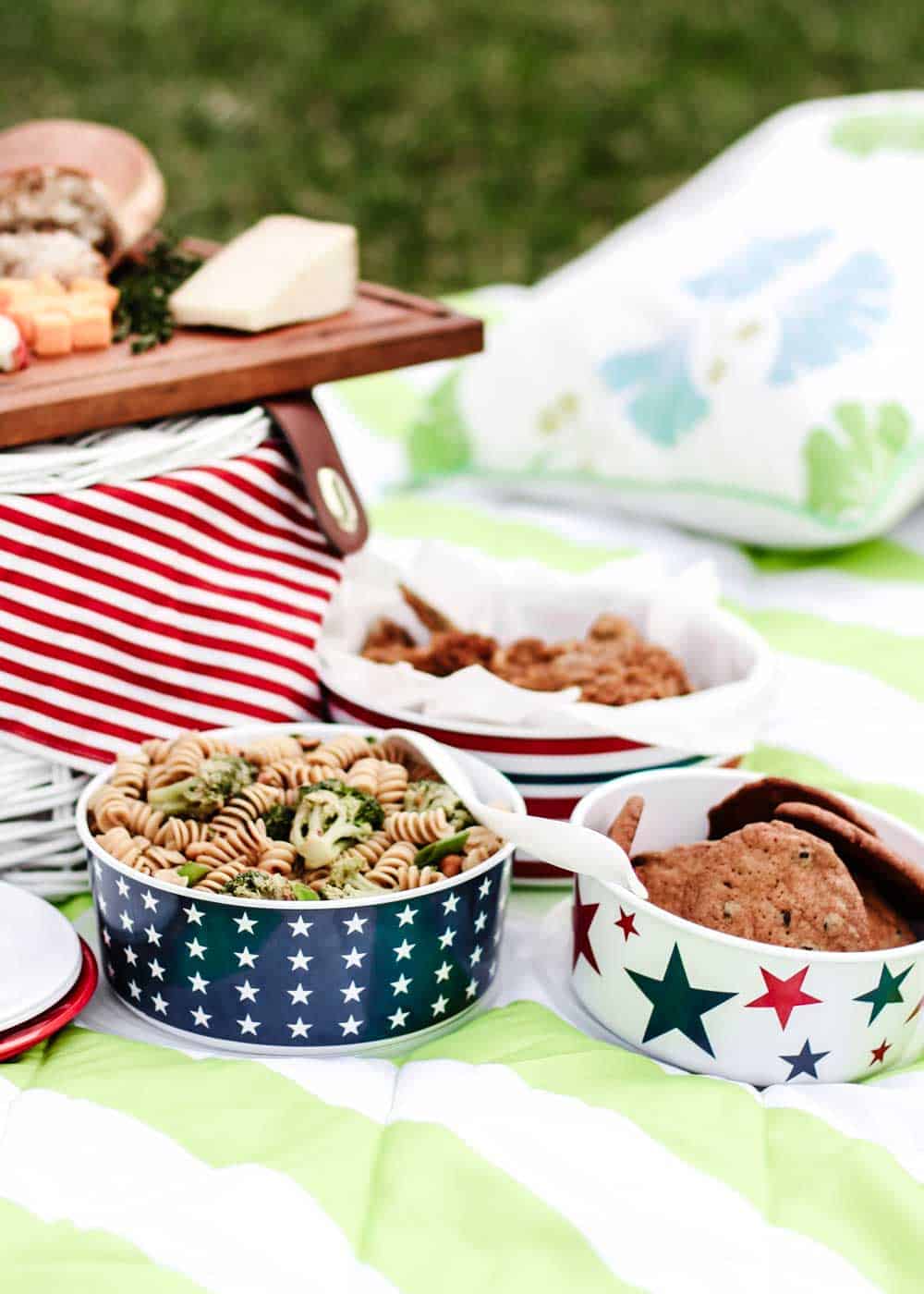 picnic blanket set up with containers of food.