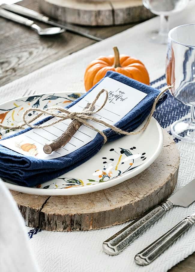 Blogger of livelaughrowe.com shares this simple fall tablescape with rustic flare and offers a free printable bookmark to use at each place setting.