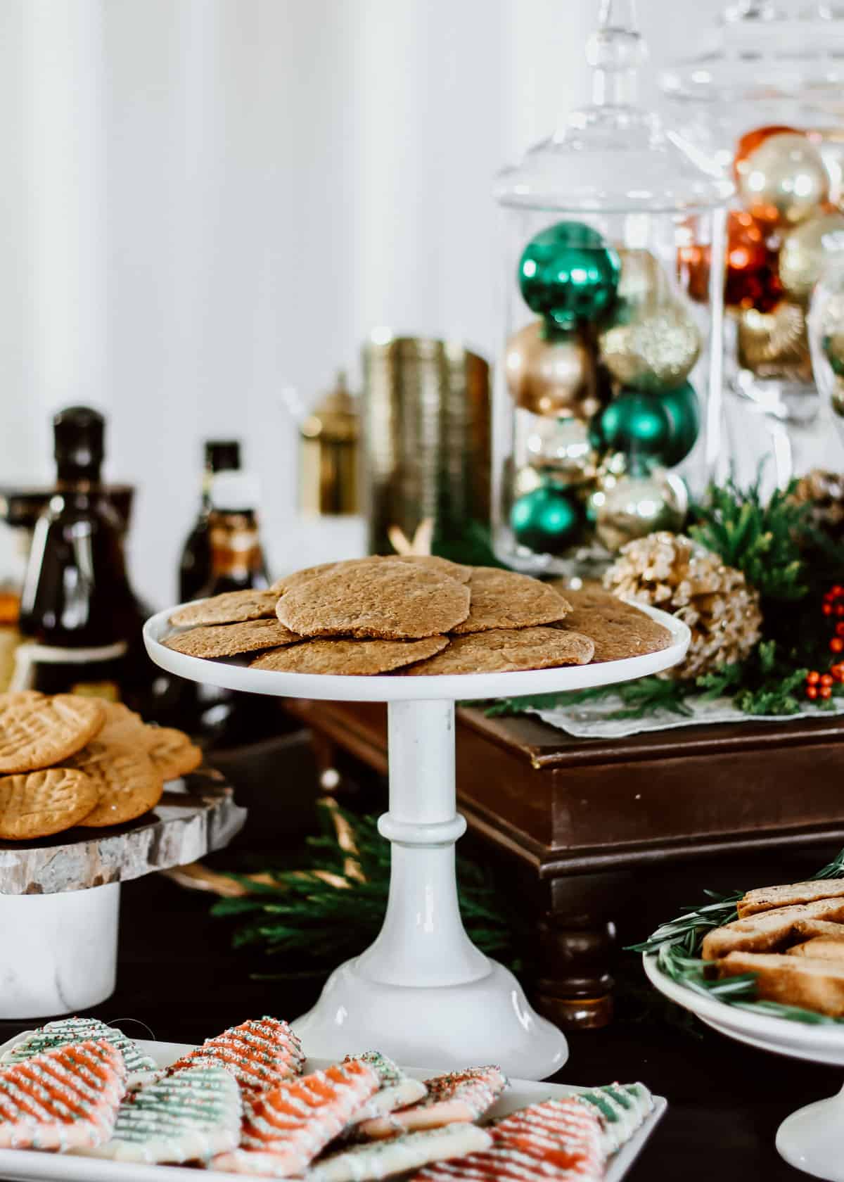white pedestal of cookies on Christmas table.