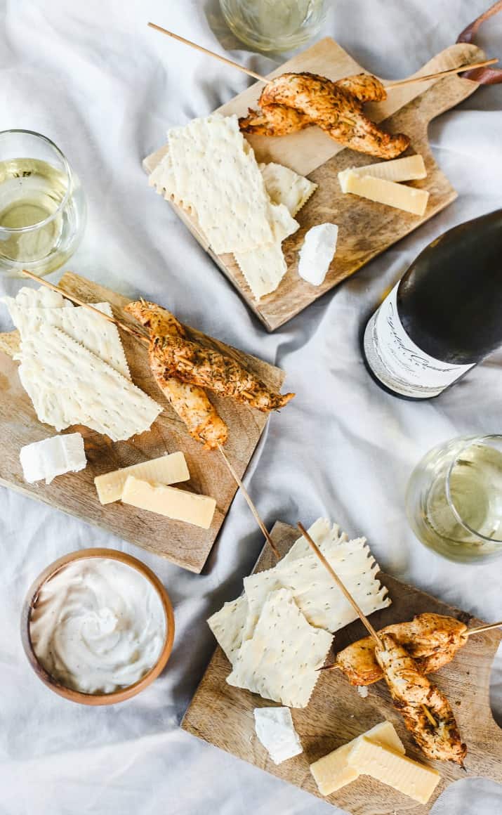 wine and appetizers on mini cheese boards