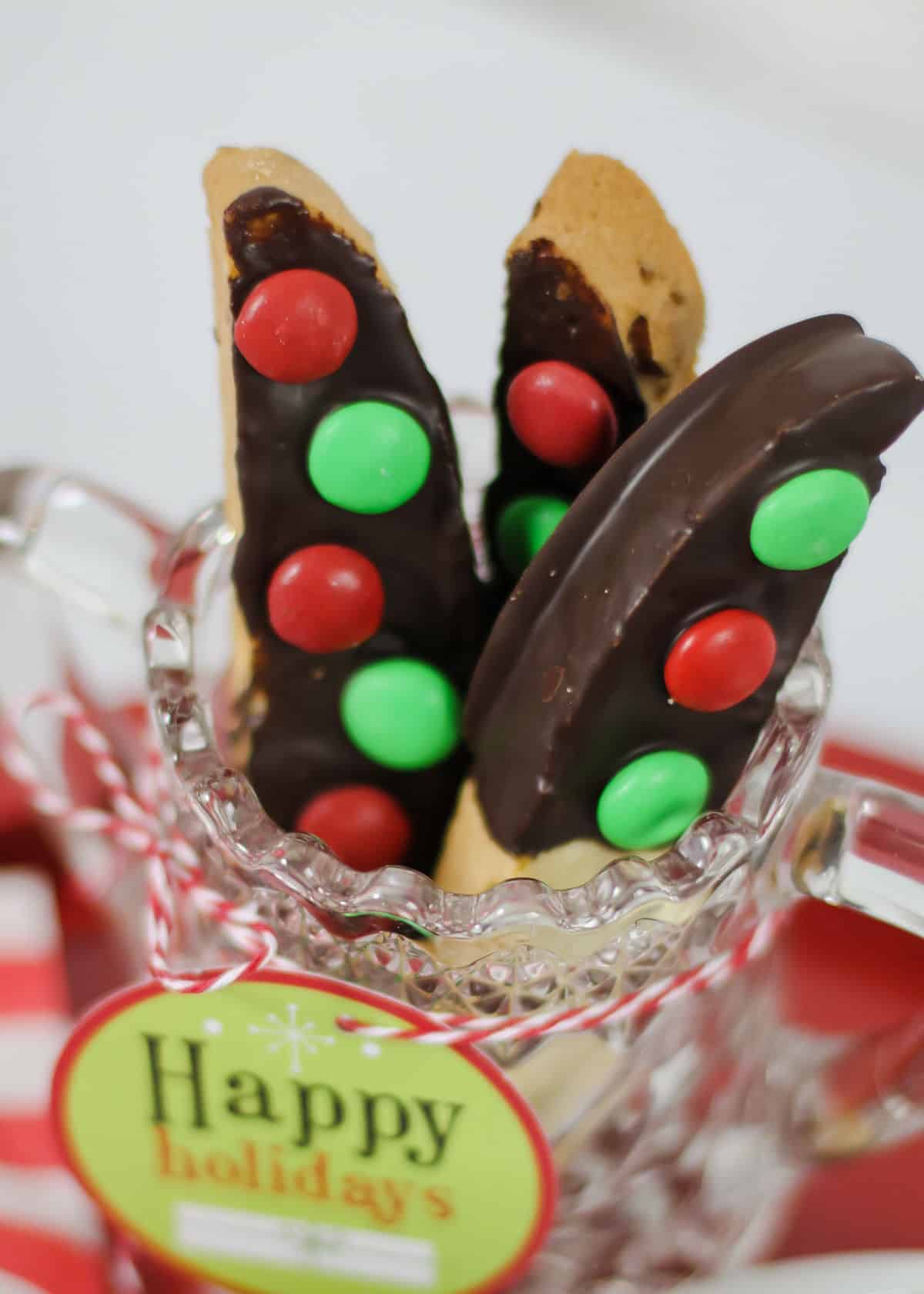 biscotti dipped in chocolate with red and green M&M's attached.