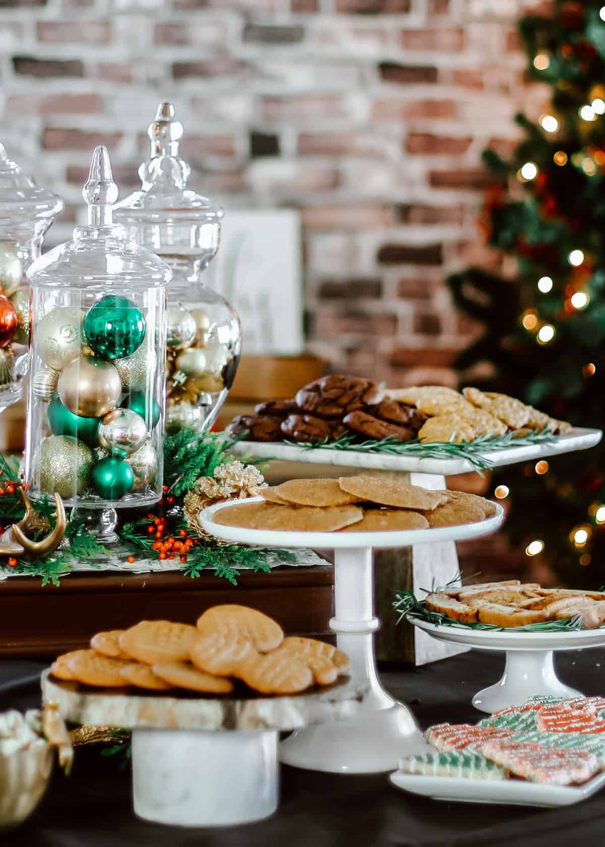 Christmas table with pedestals and trays of cookies.