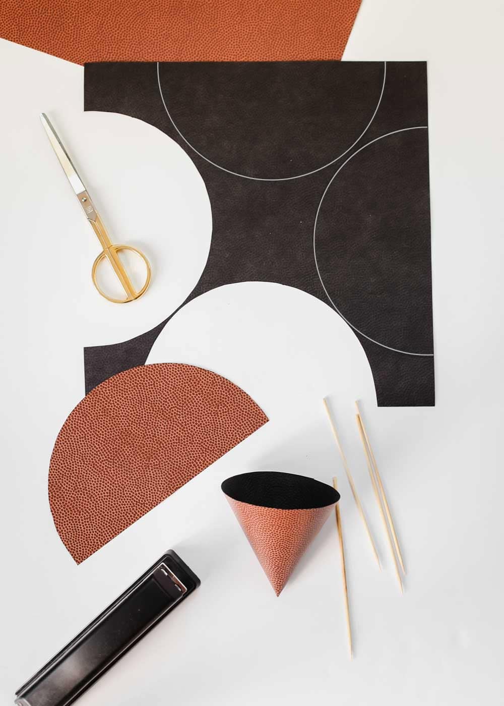 papers and supplies for making DIY food paper cones.