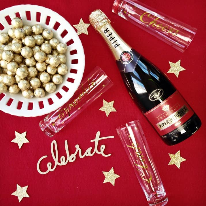 Champagne bottle on red background with gold decorations