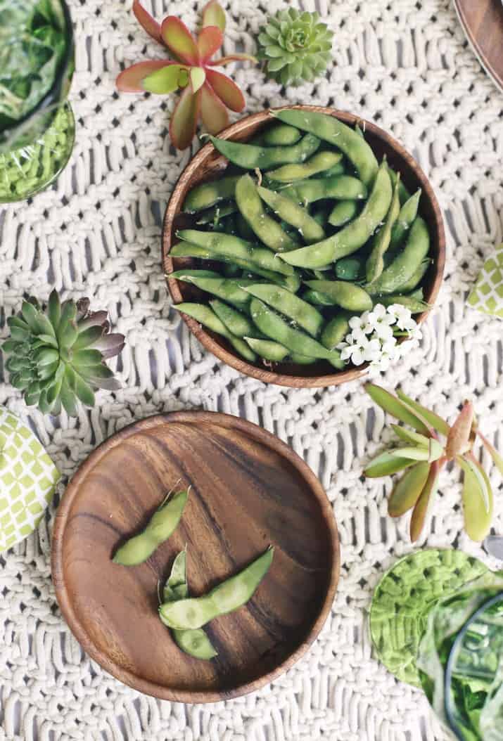 edamame appetizer on wooden plates