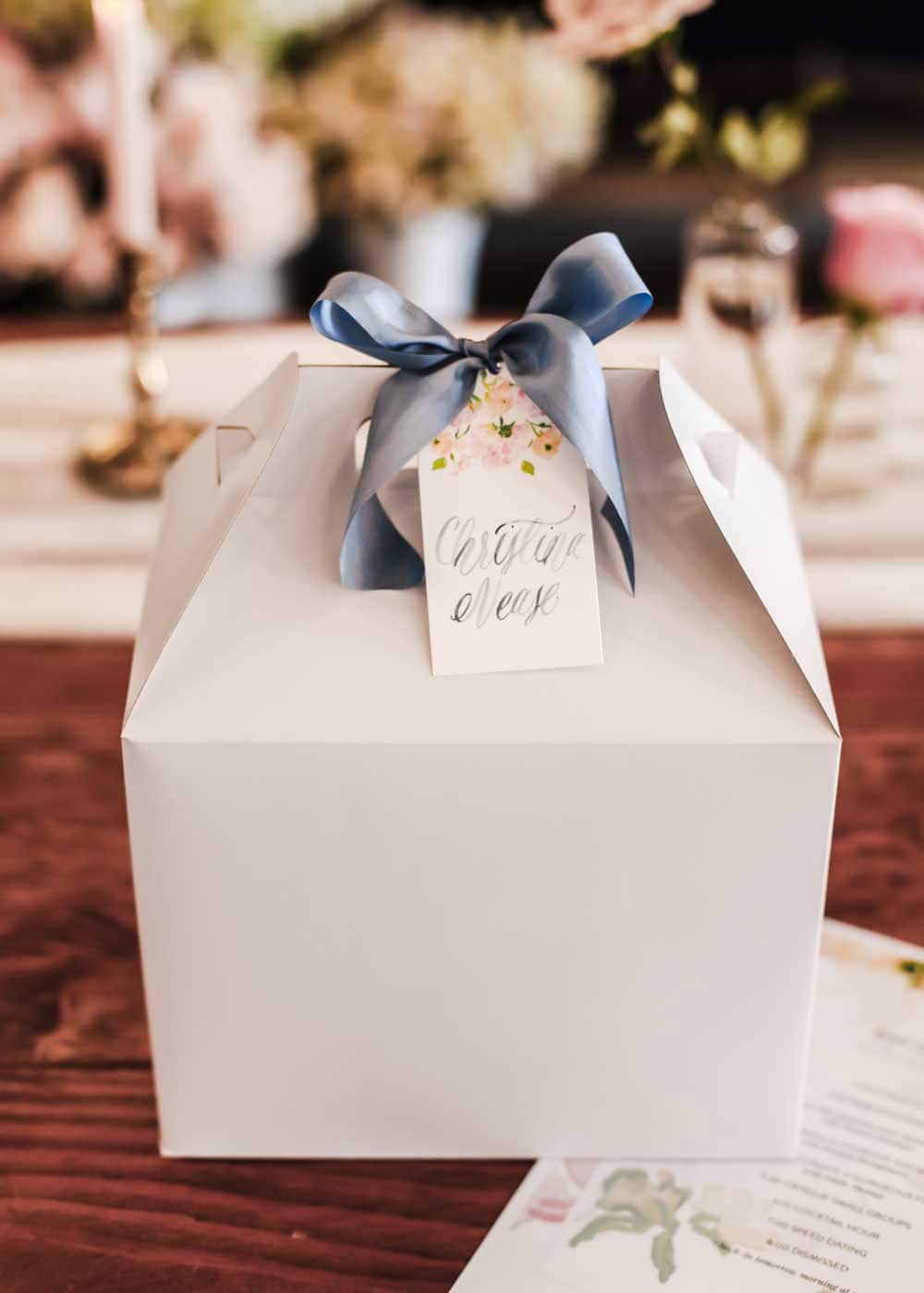 white box with name tag tied on with ribbon.